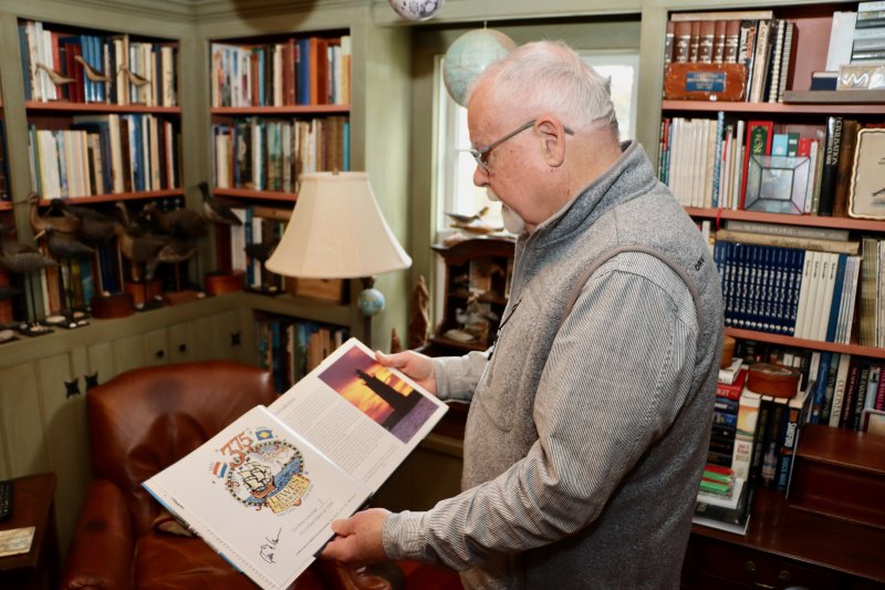 Kevin Moore looks through the coffee table book “Lewes, Delaware: Celebrating 375 Years of History.” He wrote and photographed the contents for the city’s anniversary in 2006. Moore once owned Marketplace Merchandising, a company that produced postcards and calendars with his photos. Moore grew up in the beach block of Rehoboth Avenue, in a house that is now Tiki Jac’s Street Eats & Brews.
BILL SHULL PHOTO